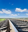 low view to railroad under deep blue sky low view to railroad under deep blue sky
