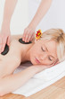 Beautiful woman receiving a massage with hot stones Beautiful woman receiving a massage with hot stones