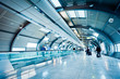 futuristic airport terminal with blurred passengers