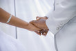 Holding Hands at their Wedding