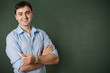 smiling student or teacher at the blackboard