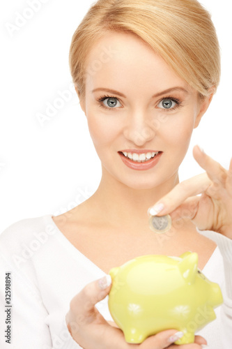 Photo: lovely woman with piggy bank and money lovely woman with piggy bank and money