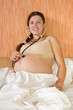 pregnant woman listens her belly