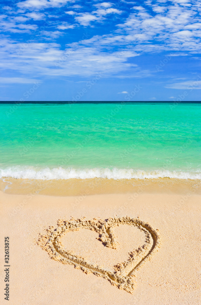 Drawing heart on beach