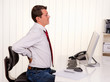 Man in office with computer and back pain
