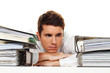 Manager in stress with stacks of files