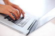 Closeup of a female hands working on a laptop