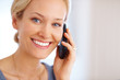 Cheerful young woman speaking on cellphone