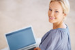 Charming young woman working on laptop