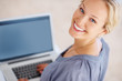Attractive woman smiling while using laptop