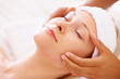 Beautiful young female receiving facial massage