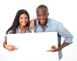 Photo: Cheerful couple showing message on whiteboard Cheerful couple showing message on whiteboard
