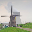 Old windmill with nuclear cooling towers, Antwerp Old windmill with nuclear cooling towers, Antwerp