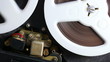 Open reel audio tape recorder reels spinning.Close-up.