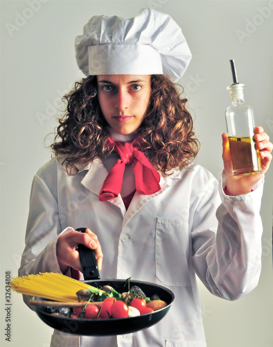 Photo: Giovane cuoca si sperimenta in cucina Giovane cuoca si sperimenta in cucina