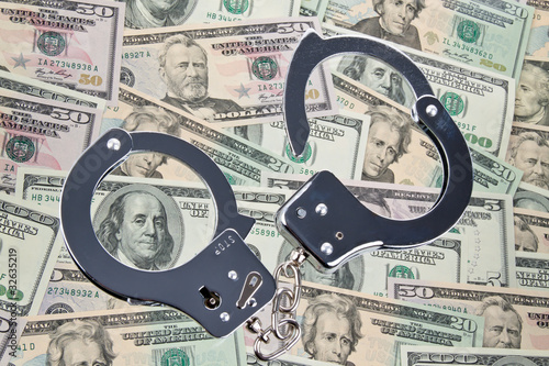 Photo: Dollar Currency notes with handcuffs Dollar Currency notes with handcuffs