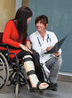 Woman with leg in plaster, doctor and chair
