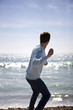 A young man throwing stones in the sea