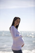 Portrait of a pregnant woman standing on the beach