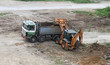 Excavator loading dirt on truck. Construction equipment at work Excavator loading dirt on truck. Construction equipment at work
