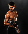 Young muscular man lifting weights