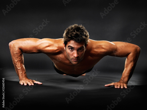 Foto: Muscular guy doing pushups Muscular guy doing pushups