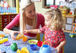 Young woman playing with girl