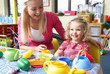 Young woman playing with girl
