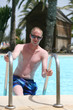 Portrait of a young handsome man in the pool