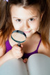 little girl with a magnifying glass