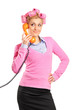 Foto: Young woman with hair rollers gossiping on a phone Young woman with hair rollers gossiping on a phone