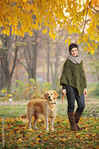 Foto: Young girl and her dog walking in autumn Young girl and her dog walking in autumn