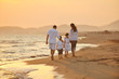 happy young family have fun on beach at sunset
