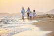 happy young family have fun on beach at sunset