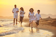 happy young family have fun on beach at sunset