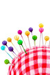 Colored pinheads in pin-cushion isolated on white