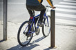 Undefined  bike rider crossing street.