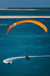 Parapentiste au dessus de l'océan avec bateau