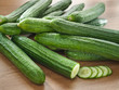 Arrangement of fresh cucumbers on a wooden decks