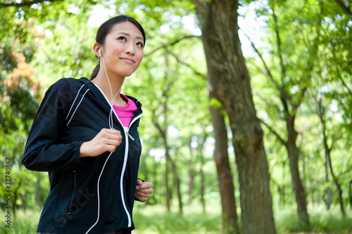 Photo: beautiful asian woman jogging in the park beautiful asian woman jogging in the park