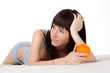 woman on bed holding orange