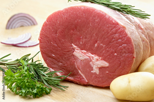 Photo: raw food, roast beef, onion, parsley, potatoes and rosemary raw food, roast beef, onion, parsley, potatoes and rosemary