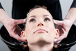 Beautiful young woman getting a hair wash. In a hair salon
