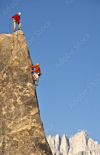 Photo: Rock climber rappelling. Rock climber rappelling.