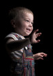 Little boy smiles in colorful pants
