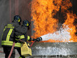 Firefighters extinguish a large fire with a fire extinguisher