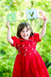 Happy little girl holdind-up words love