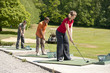 golfers inline at the driving range golfers inline at the driving range