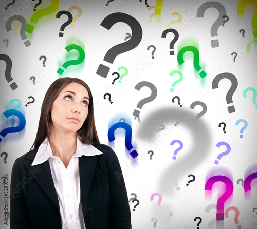 Photo: businesswoman with question marks businesswoman with question marks
