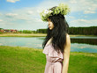 Beautiful girl wearing a wreath of wildflowers